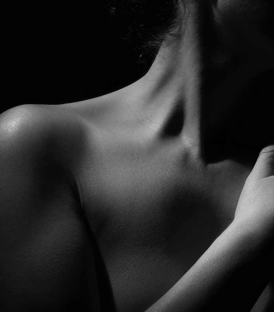 Détail artistique des épaules et du cou d’une femme lors d’une séance photo boudoir au studio Les Délices d’un Regard à Tourcoing.